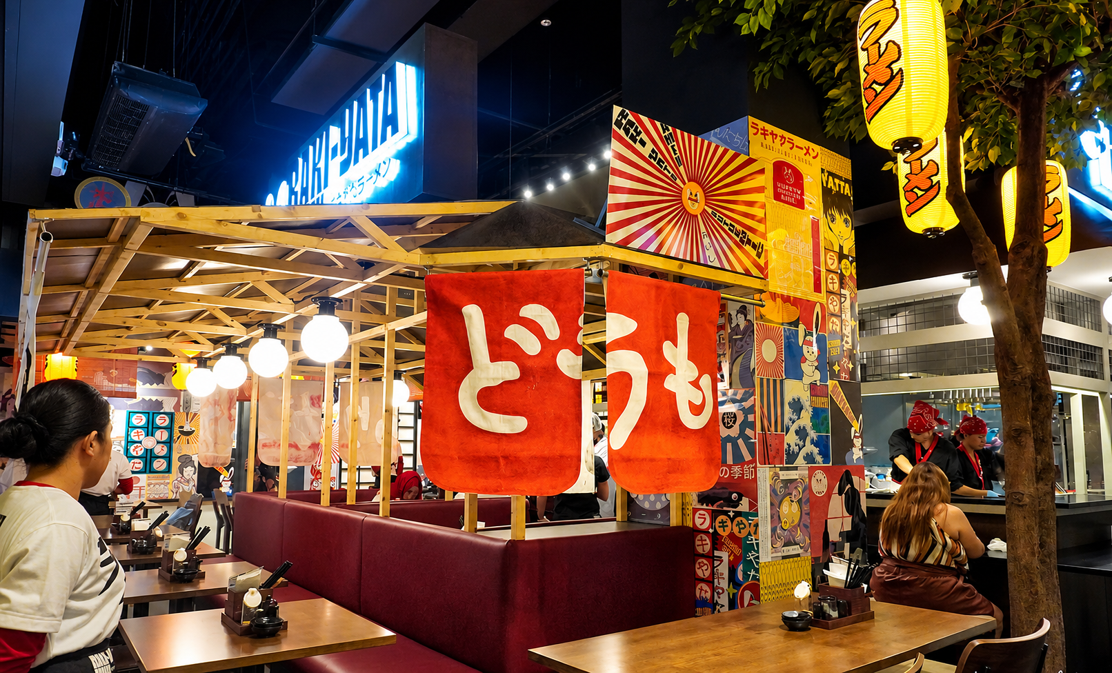 Inside Raki-Yata Ramen — red noren curtains and warm lanterns fill the restaurant