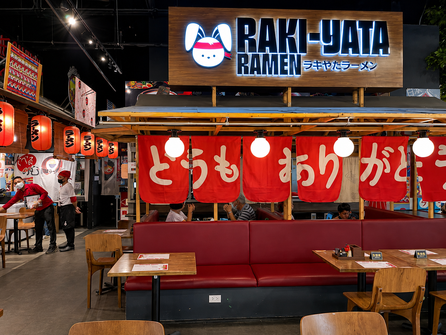 Inside Raki-Yata Ramen — red noren curtains and warm lanterns fill the restaurant
