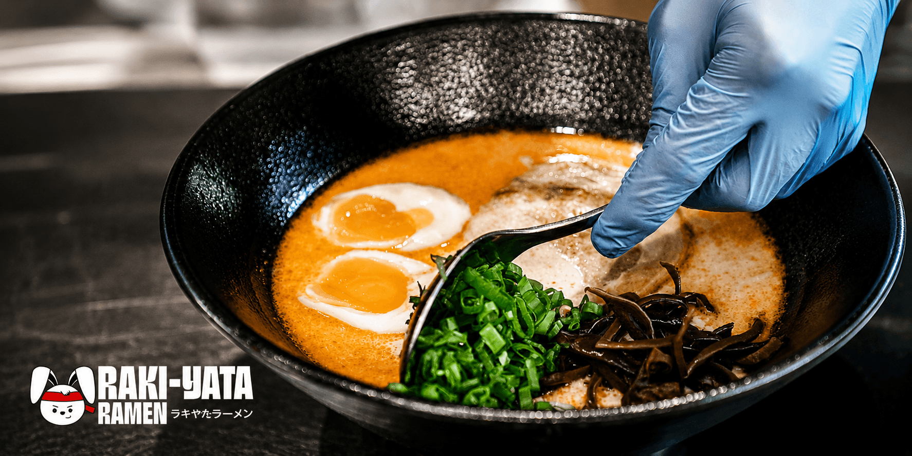Inside Raki-Yata Ramen — red noren curtains and warm lanterns fill the restaurant
